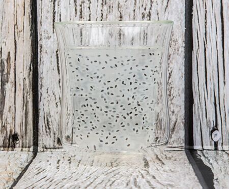 Sweet basil seed drink in a bottle over wooden backgroundの写真素材