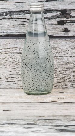 Sweet basil seed drink in a bottle over wooden backgroundの写真素材