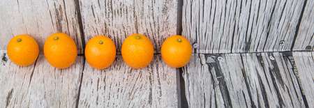 Kumquat fruit over wooden backgroundの写真素材