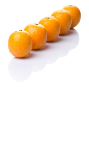 Fresh kumquat fruits over white backgroundの写真素材