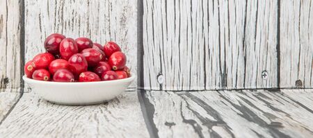 Cranberries fruit over wooden backgroundの写真素材
