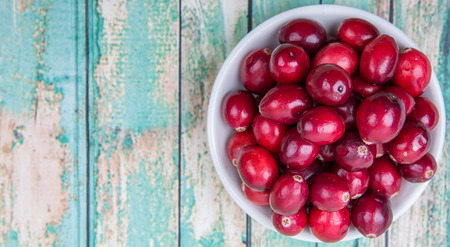 Cranberries fruit over wooden backgroundの写真素材