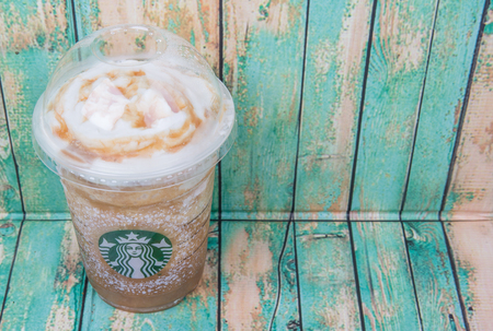 TOKYO, JAPAN - DECEMBER 2ND, 2015. Starbuck frapuccino over wooden background. Founded in 1971, Starbucks is the largest coffeehouse company in the world.のeditorial素材
