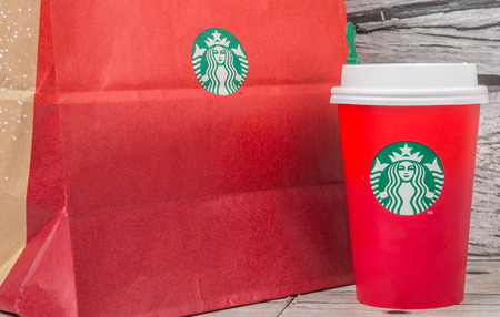 TOKYO, JAPAN - DECEMBER 2ND, 2015. Starbucks frapuccino and holiday beverage over wooden background. Founded in 1971, Starbucks is the largest coffeehouse company in the world.のeditorial素材