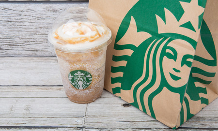 TOKYO, JAPAN - DECEMBER 2ND, 2015. Starbuck frapuccino over wooden background. Founded in 1971, Starbucks is the largest coffeehouse company in the world.のeditorial素材