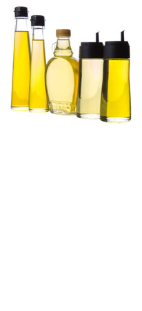 Sesame seed oil, flax seed oil, olive oil, corn oil and vegetable oil in bottles over white backgroundの写真素材