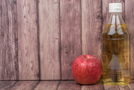 Apple vinegar over wooden backgroundの写真素材