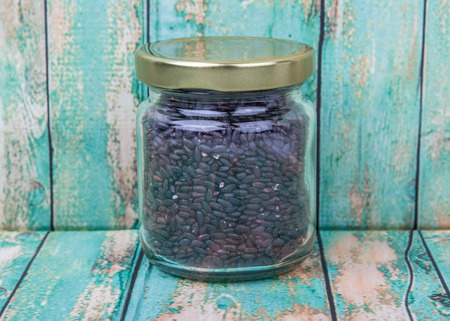 Black millet in mason jars over wooden backgroundの写真素材