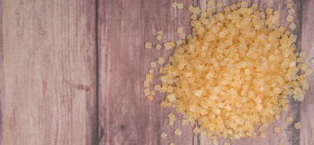 Brown sugar over wooden backgroundの写真素材