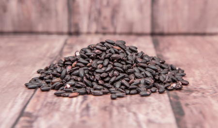 Black millet grains over wooden backgroundの写真素材