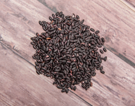 Black millet grains over wooden backgroundの写真素材