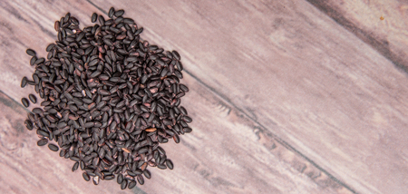 Black millet grains over wooden backgroundの写真素材