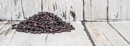 Black millet grains over wooden backgroundの写真素材