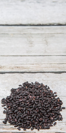 Black millet grains over wooden backgroundの写真素材