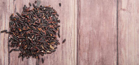 Black glutinous rice over wooden backgroundの写真素材