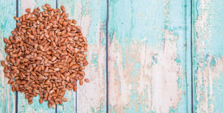 Brown millet grain over wooden background