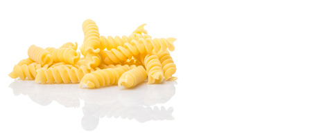Dried corkscrew shape pasta or fusilli pasta over white backgroundの写真素材