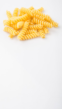 Dried corkscrew shape pasta or fusilli pasta over white backgroundの写真素材