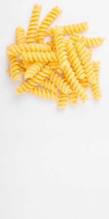 Dried corkscrew shape pasta or fusilli pasta over white backgroundの写真素材