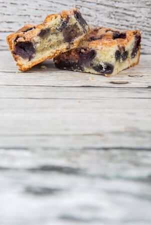 Portions of delicious homemade blueberry sponge cakes over wooden backgroundの写真素材