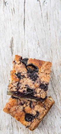Portions of delicious homemade blueberry sponge cakes over wooden background