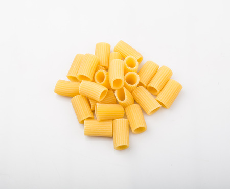 Rigatoni pasta or tube shaped pasta over white backgroundの写真素材