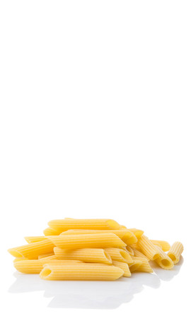 Dried penne regate pasta over white backgroundの写真素材