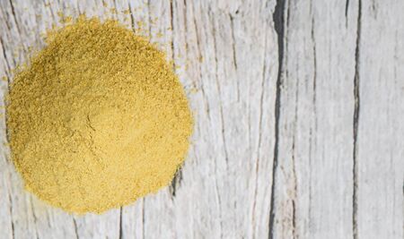 Dried bakers yeast over wooden background