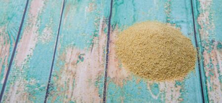 Dried bakers yeast over wooden backgroundの写真素材