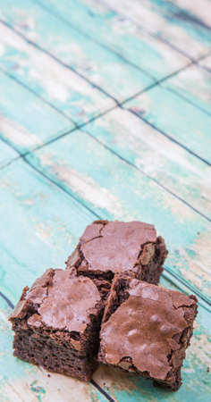 Homemade chocolate brownies over wooden backgroundの写真素材
