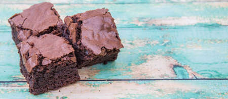 Homemade chocolate brownies over wooden backgroundの写真素材