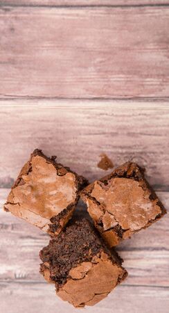 Homemade chocolate brownies over wooden backgroundの写真素材