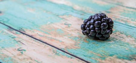 Blackberry fruit over wooden background