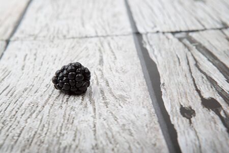 Blackberry fruit over wooden background