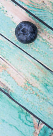 Blueberry fruit over wooden background