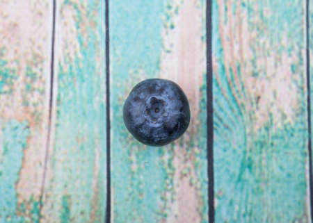 Blueberry fruit over wooden background