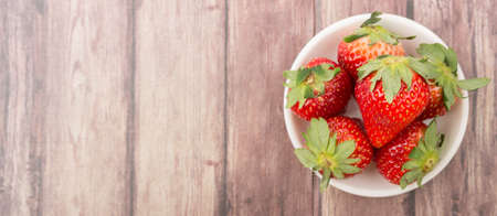 Strawberry fruit over wooden backgroundの写真素材