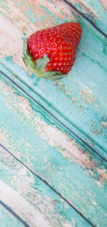 Strawberry fruit over wooden backgroundの写真素材