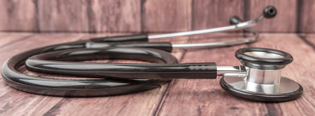 Medical stethoscope over wooden backgroundの写真素材