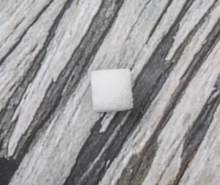 Sugar cube over wooden background