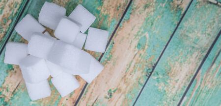 Sugar cubes over wooden backgroundの写真素材
