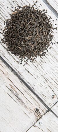 Dried black tea leaves over wooden backgroundの写真素材