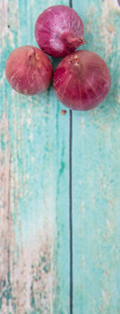 Shallots over wooden backgroundの写真素材