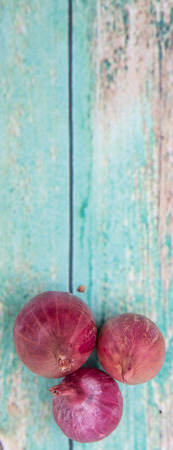 Shallots over wooden backgroundの写真素材