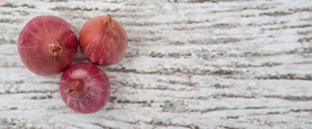 Shallots over wooden background