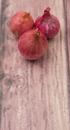 Shallots over wooden backgroundの写真素材