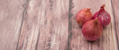 Shallots over wooden background
