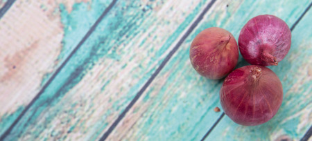 Shallots over wooden backgroundの写真素材