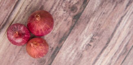Shallots over wooden backgroundの写真素材
