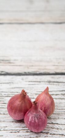 Shallots over wooden backgroundの写真素材